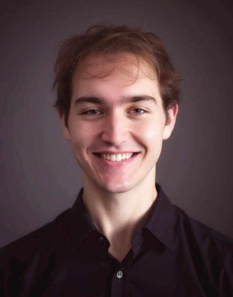 A headshot photo of Logan Jorgensen (me) in a brown shirt